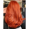 Long wavy synthetic orange hair wig for women with ombre layers and voluminous curls - Orange Red