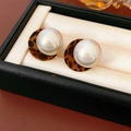 Detailed close-up of plush leopard print earrings with large lustrous white pearls - Silver Pin Leopard