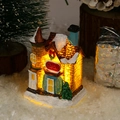 Macro shot of resin Christmas village house with LED lights and snow-covered roof - Style A Small House