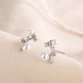 Elegant branch shaped silver stud earrings with pearls and zircon stones on beige fabric - Silver