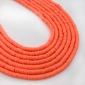 Orange flat clay disc beads in stacked rows for DIY jewelry making and bracelets - Orange