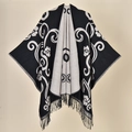 Detailed view of the vintage floral pattern and tassel hem on the reversible shawl - 130x150cm / Black Paisley Pattern