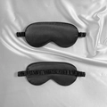 Satin silk sleep eye mask in black featuring elastic head strap and glossy texture - Black