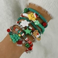 Close-up of layered Christmas charm bracelets with reindeer and Santa pendants on wrist - Xmas Multi-layer Braided(31223-bra-col)
