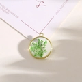Golden round resin pendant with green dried flowers and metal loop for DIY jewelry - Style 10