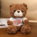 Orsetto marrone con maglietta bianca cuore I Love You, peluche riccio per San Valentino - Orso bruno scuro Maglietta multi-cuore / 20cm