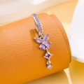 Silver belly button ring with purple butterfly and zircon pendants on orange stand - Butterfly Style (Silver Purple)
