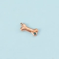 Macro detail of rose gold bone pendant with sparkling blue zircon stone and hanging loop - Rose Gold December
