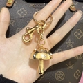 Macro shot of a golden mushroom keychain with white rhinestones on a handbag - Gold with White Rhinestone Mushroom