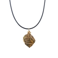Detailed macro view of raw tiger eye stone pendant wrapped in handmade golden wire - Tiger's Eye