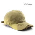 Distressed stone-washed baseball cap in yellow with vintage frayed details for street style - Yellow
