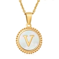 Macro detail of round 18K gold necklace with shimmering white shell and V initial - Letter V