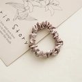 Close-up of champagne satin scrunchie with silk texture and elastic inner band detail - 6cm Satin Champagne