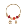 Bracciale regolabile dorato con cristalli rossi e ciondoli celesti a forma di sole - Stile Stella Luna Sole / Rosso