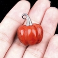 Ciondolo zucca in pietra rossa con anello in argento mostrato nel palmo della mano - Diaspro Rosso