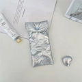 Detail of silver butterfly quilted PU leather eyewear pouch with blue heart clasp - Small Bow Silver