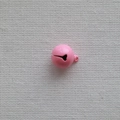 Close-up of a 14mm pink metal pet bell with a hanging loop on a beige fabric background - Deep Pink