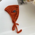 Handmade orange knit bonnet with floral embroidery and green trim for winter warmth - Orange