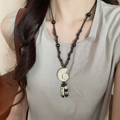 Detail of ethnic pearl flower necklace with conch pendant and bead tassels on woven cord - Wax Rope Ceramic Conch Wood (20#)