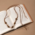 Close-up of handmade boho waist chain with brown braided rope and natural sea shells - Dark Brown Wax Rope Natural Shell Tassel (X451-18)