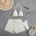 Flat lay of white three-piece bikini set with textured fabric and wavy edge shorts - S / White