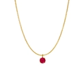 Golden necklace with round red birthstone pendant on a minimal white background - July
