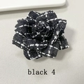 Close-up of black houndstooth tweed camellia flower brooch with intricate stitching detail - Black Tweed