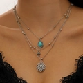 Three-layer silver necklace with lapis teardrop and bohemian charms on a model - 3-Layer Silver Disc Necklace (35 Silver 11213)