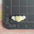Mini resin heart with wings charm shown on a scale measuring 2.5cm in width - Wings Heart / Mini / Yellow