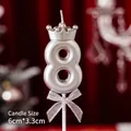 Silver number 8 birthday candle with crown and bow on deep red background - Number Candle Crown Bow Silver 8