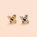 Close-up of gold and silver bee cartilage studs with sparkling crystals and enamel - 1# Bee-Gold