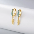 Macro shot of s925 silver turquoise feather earrings with engraved certification mark - Gold