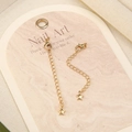 Detailed macro of two 18k gold-plated extension chains with lobster clasps and star pendants - No.5 Gold Plated Star