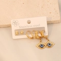 Detailed close-up of 3-pair gold stainless steel evil eye earring set on stone - 3 Pairs Classic Evil Eye Hoop Set (7#)