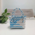 Detail of blue and white woven basket bag with geometric patterns on a white table - Mini Blue and Grey Contrast
