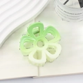 Floral claw clip with a matte green gradient finish shown in a lifestyle setting - 6.5*6*4.3 / Green