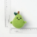 Handmade crochet pear keychain with cute face expression and green leaf detail - Smiley Green Pear Doll
