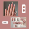 Detail view of pink and nude French tip press-on nails with delicate heart patterns - W033 Nude Pink Heart