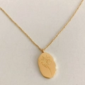 Elegant gold necklace with oval floral pendant featuring December birth flower design - May Lily