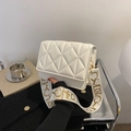 White quilted PU leather crossbody bag with wide strap and gold hardware accents - White