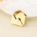 Macro shot of an openable gold envelope pendant with an inner card on a ceramic tray - Envelope Set / Gold
