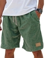 Detail of green linen men's leisure shorts featuring elastic drawstring waist and leather patch - Green