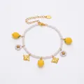 Detail view of pearl bracelet with lemon, bee, and daisy charms on stainless steel chain - Lemon Bee Daisy Multi-Pendant Style (TXE288-3)