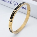 Bracciale rigido in acciaio dorato con disegni smaltati di sole, luna e stelle - Oro Nero