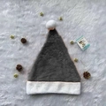 Gray plush Christmas hat with white faux fur trim and pompom on soft white background - Grey Plush Hat