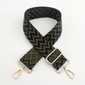 Close-up of black and olive green geometric woven strap with gold metal swivel hooks - Black Army Green
