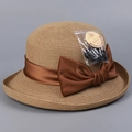 Detail of woven straw hat with brown satin bow and UPF 50+ sun protection tag - M(56-58cm) / Khaki