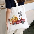 Hello Fall canvas tote bag with pumpkin and red truck print shown on a female model - Hello Fall Truck / White