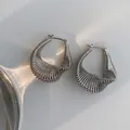 Minimalist silver twist U-shaped earrings featuring textured wire winding and metallic finish - Silver