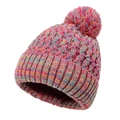 Macro view of multi-colored chunky knit beanie with vibrant faux fur pompom detail - Rainbow Rose Red